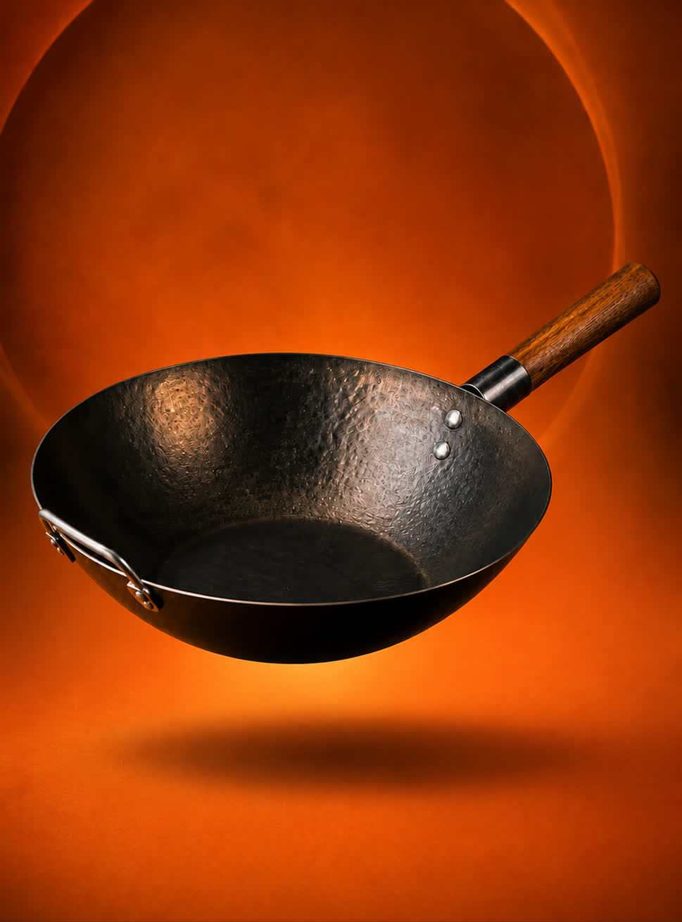 KUROGANE carbon steel wok against a glowing orange backdrop